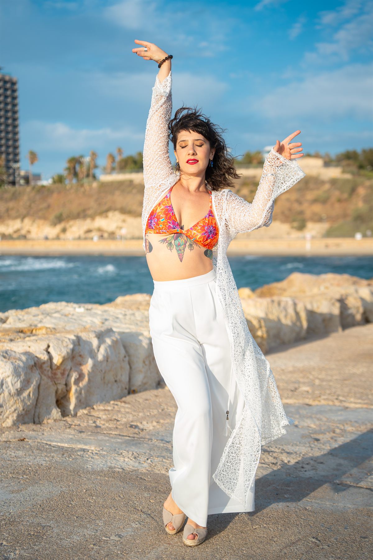 Gal BePole dancing by the sea