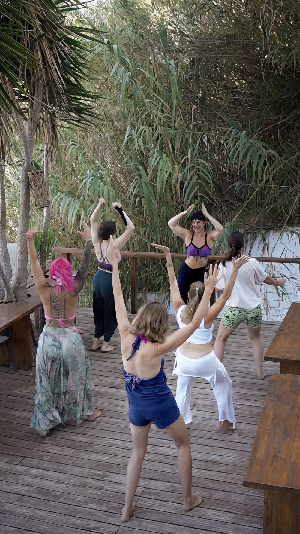 A group dancing together on an outdoor deck
